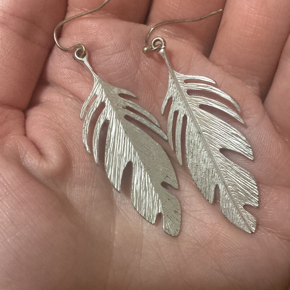 Silver tone feather earrings